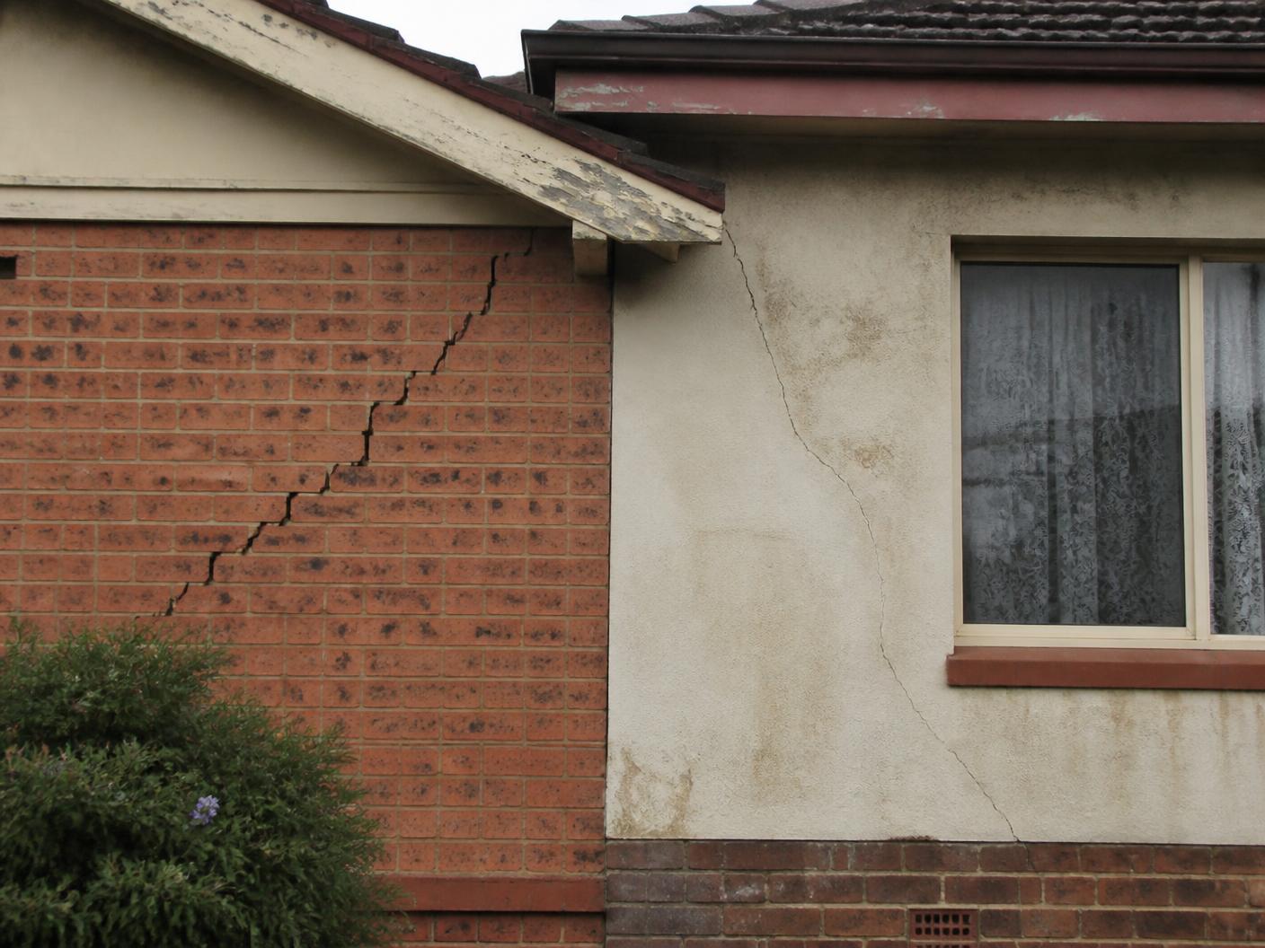 Stepped crack through brickwork and render on a house exterior