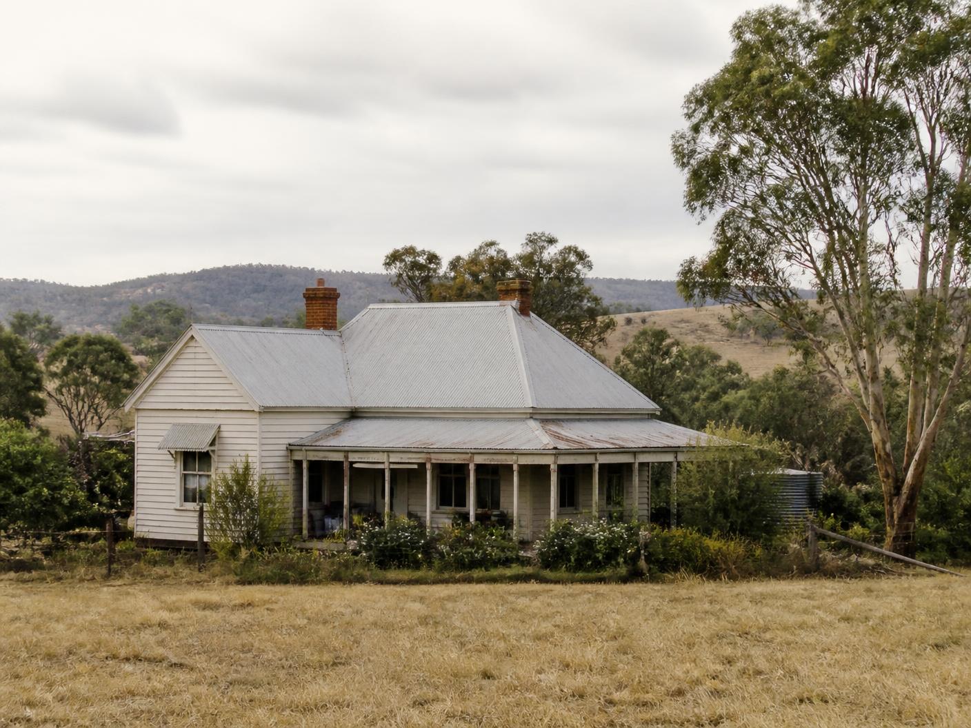 Weatherboard farmhouse with corrugated iron roof in rural Victoria